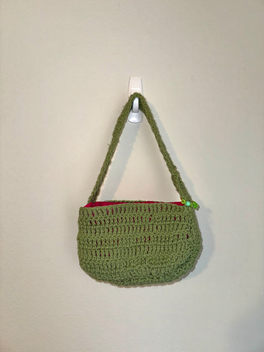 Lined green handbag with charms